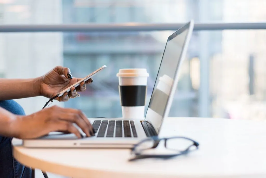 How a Fixed Rate Heloc Works - Woman Using Phone and Laptop