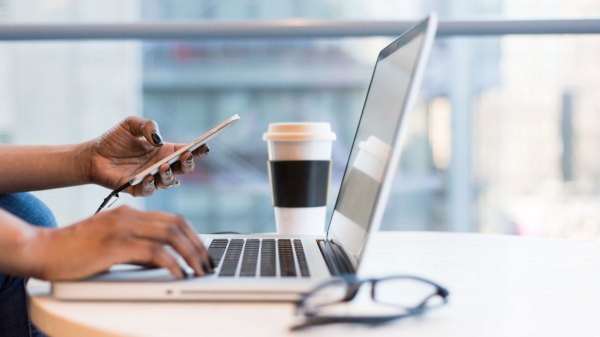 How a Fixed Rate Heloc Works - Woman Using Phone and Laptop