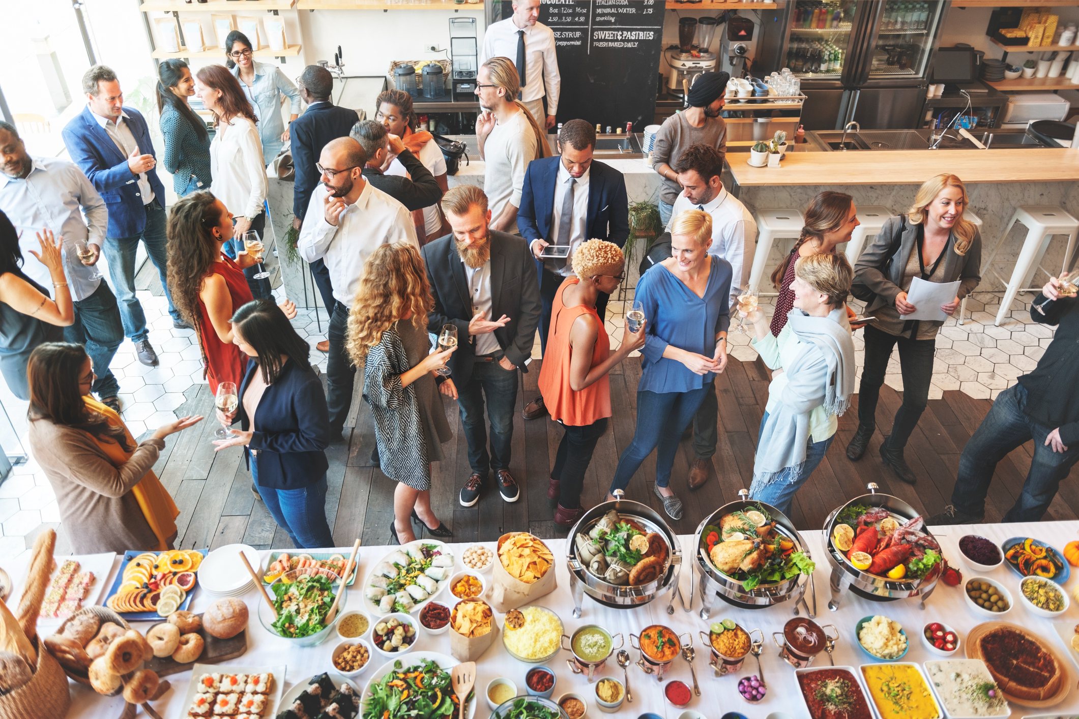 party goers gathering around the buffet table