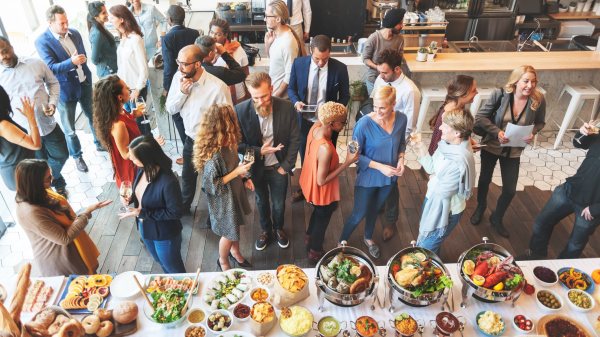 party goers gathering around the buffet table
