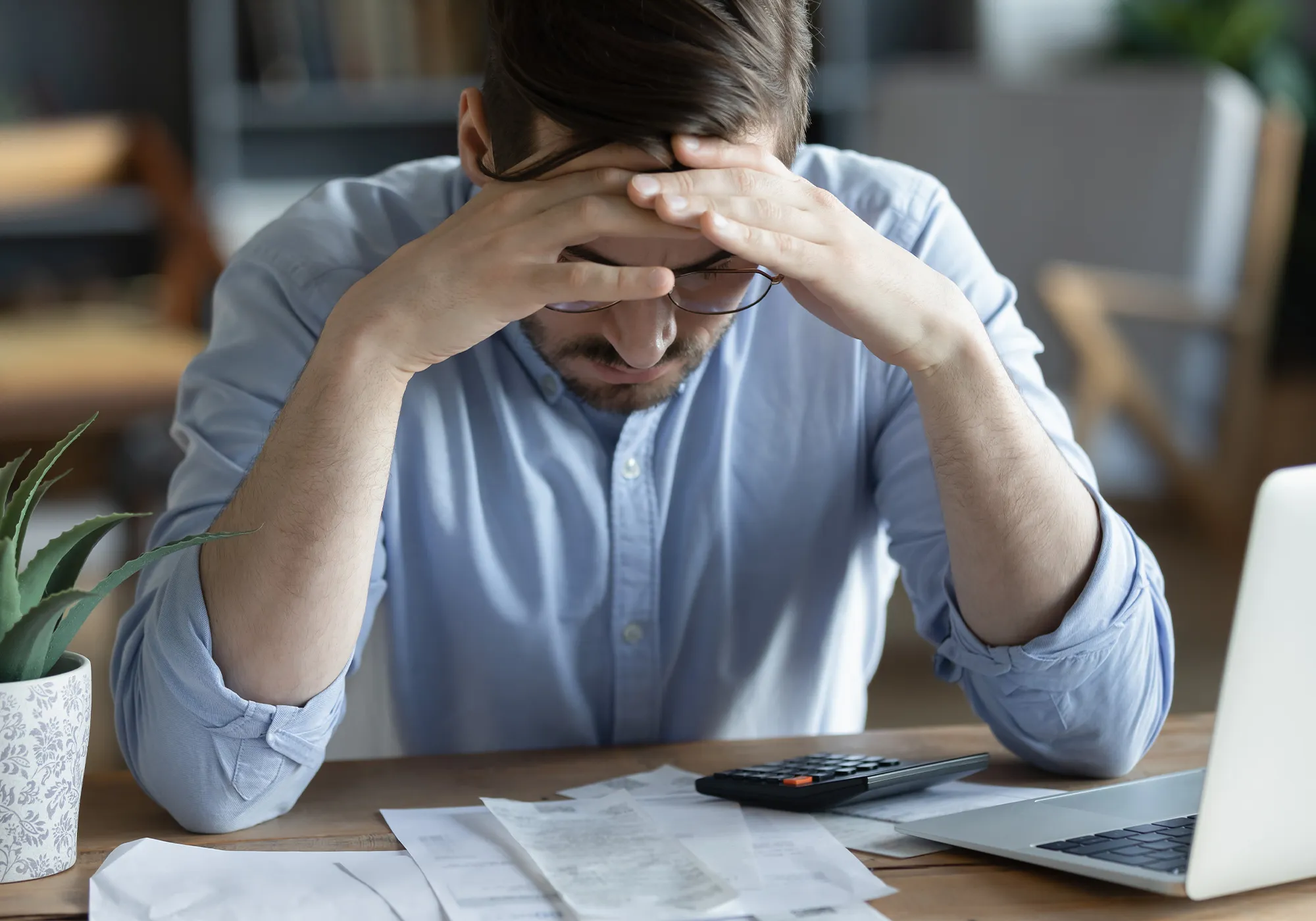 Man pondering bankruptcy paperwork