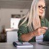 Woman makes credit card balance transfer to pay off debt