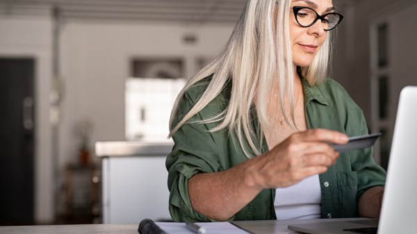 Woman makes credit card balance transfer to pay off debt