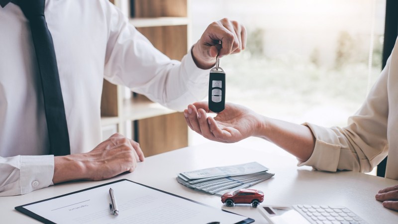 man receiving car keyus after getting answer to can i use heloc to buy a car