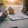 Real estate professionals offer their clients contracts to discuss home purchases