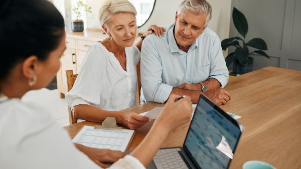 Financial advisor consulting with clients on end-of-life documents