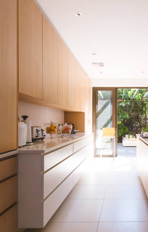 Clean kitchen and sliding door open to the outdoors