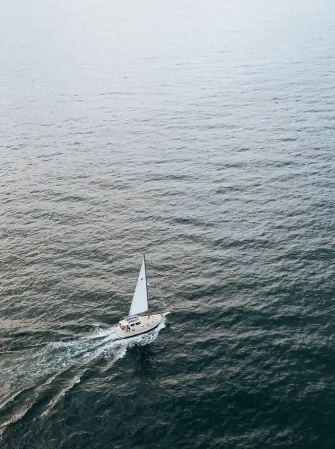Aerial view of yacht sailing in open water