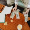 A person budgeting money in a coffee table