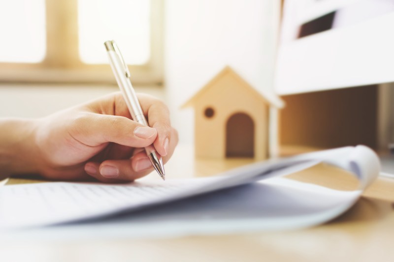 Close up hand signing  loan document