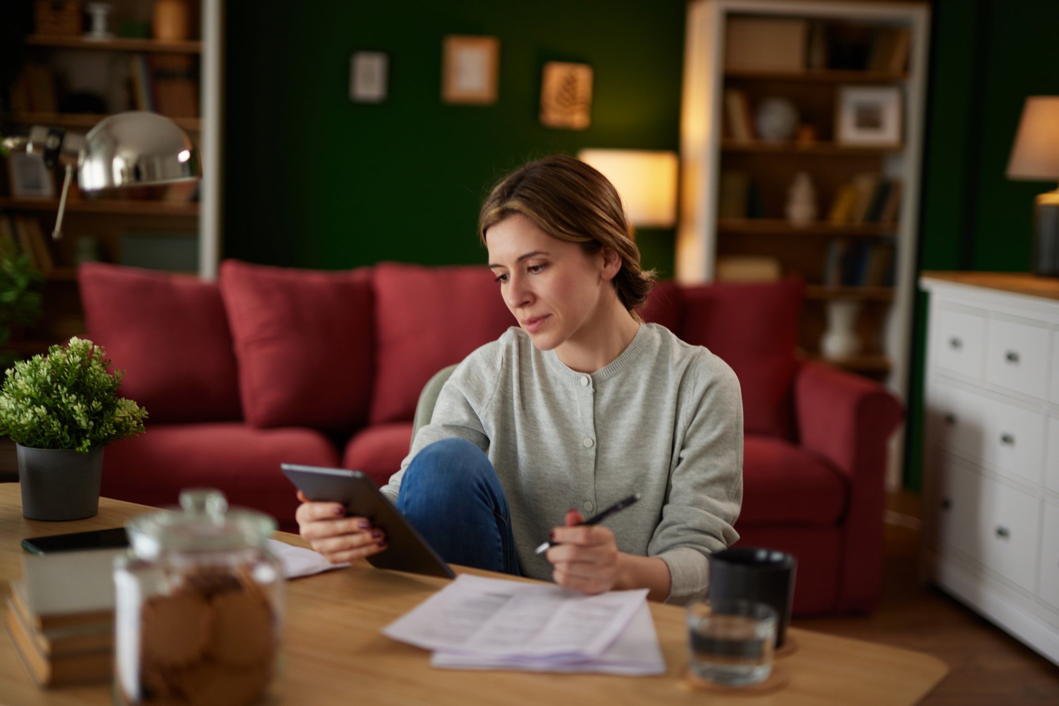 Women using digital tablet to check her finances at home office