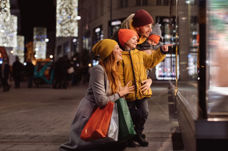 Family with two kids in front of the store window