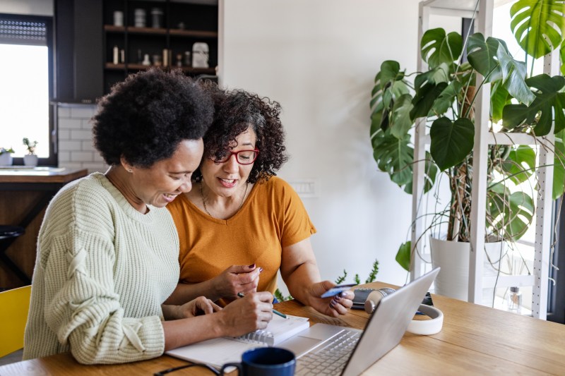 Couple sitting at the table in the kitchen making financial plans.